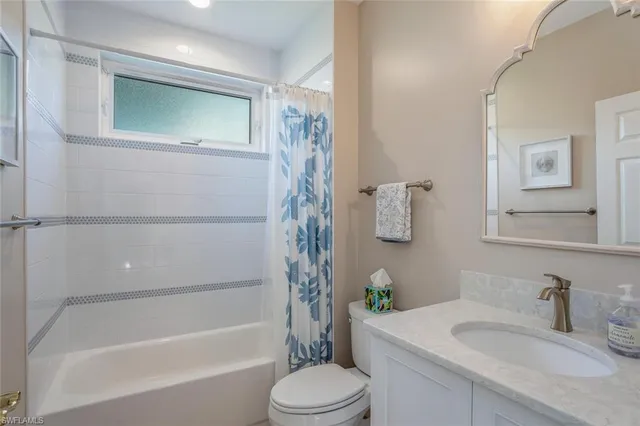 a spacious bedroom with a bed and a chandelier