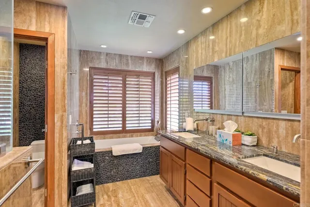 a kitchen with granite countertop sink and cabinets