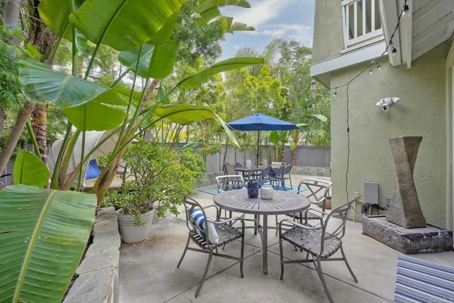a view of a patio with furniture and a yard
