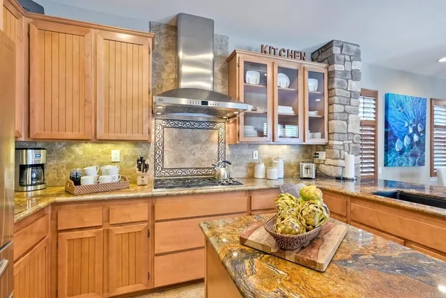a kitchen with stainless steel appliances granite countertop a sink stove and cabinets