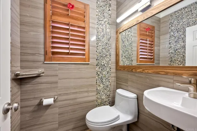 a bathroom with a toilet a sink and a window