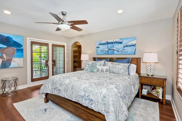 a bedroom with a bed a couch and a large window