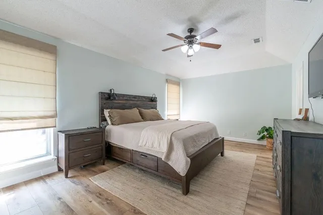 a bedroom with a bed and window