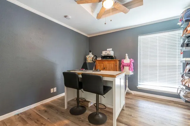 a view of a workspace with furniture and wooden floor
