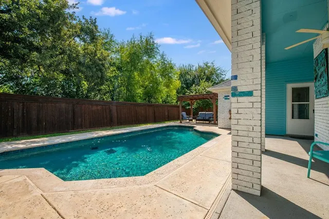 a view of backyard with seating area and green space
