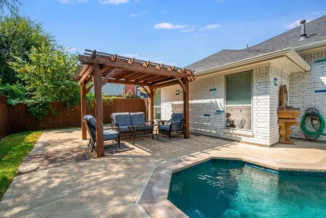 a view of a house with backyard porch and sitting area