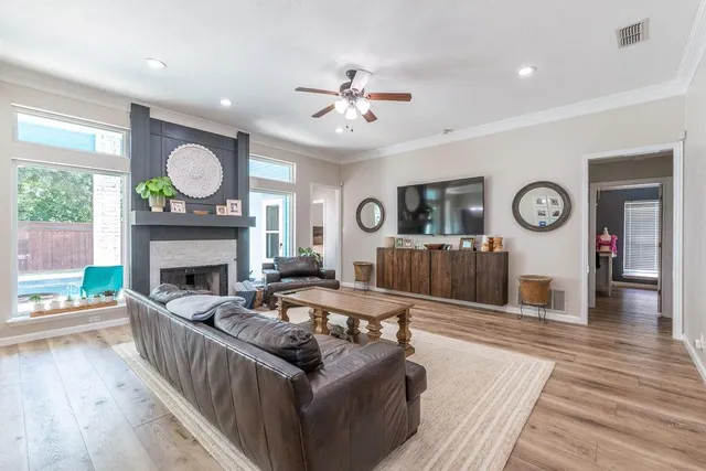 a living room with furniture a clock and a fireplace
