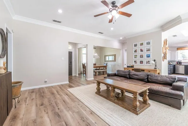 a living room with furniture and a chandelier
