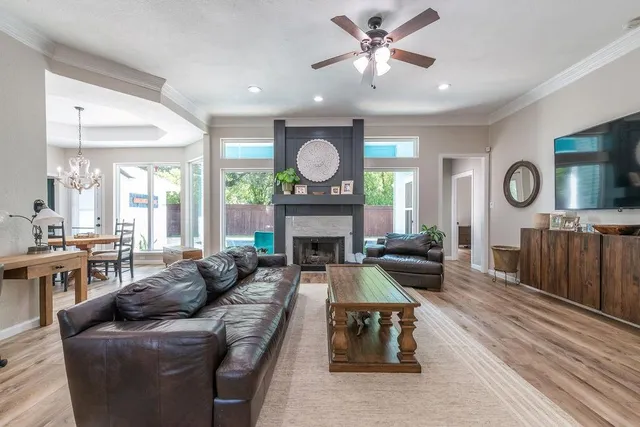 a living room with furniture a fireplace and a window