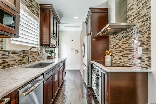 a kitchen with a sink stove and refrigerator