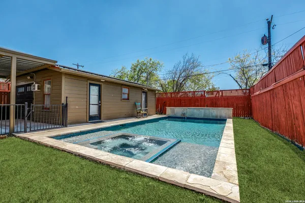 a view of backyard with wooden fence