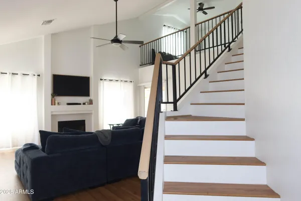 a living room with furniture a fireplace and a flat screen tv