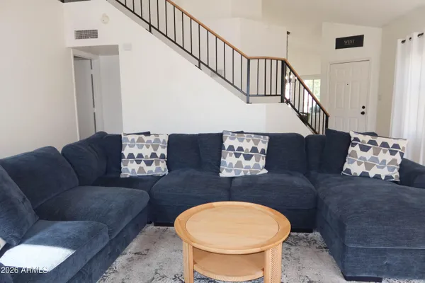 a living room with furniture flowerpot and a table