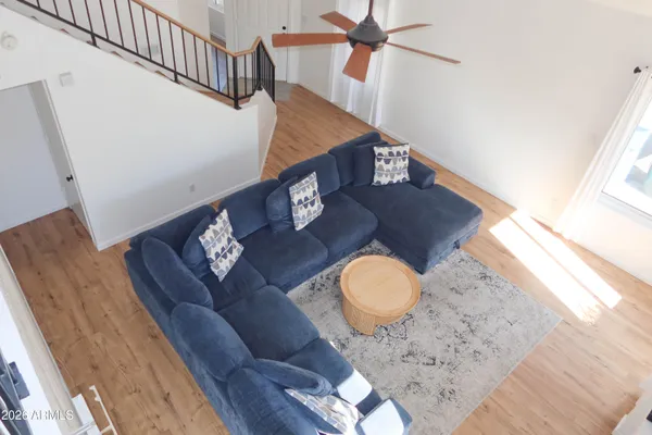 a living room with table chairs and wooden floor