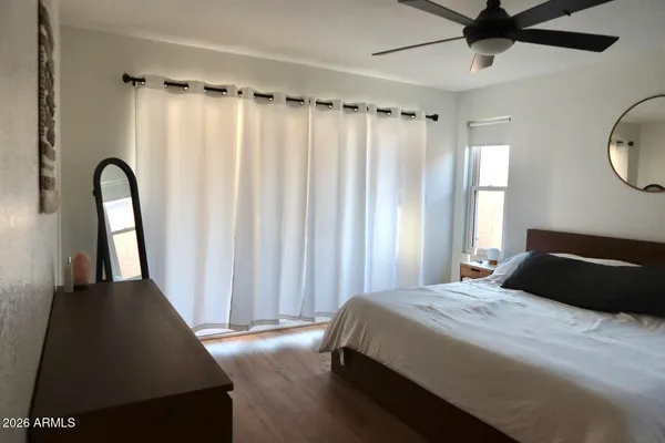 a bedroom with a bed and a window