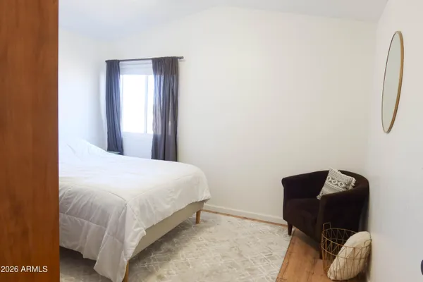 a bedroom with a bed and chair