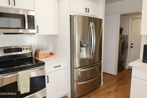 a kitchen with stainless steel appliances and refrigerator