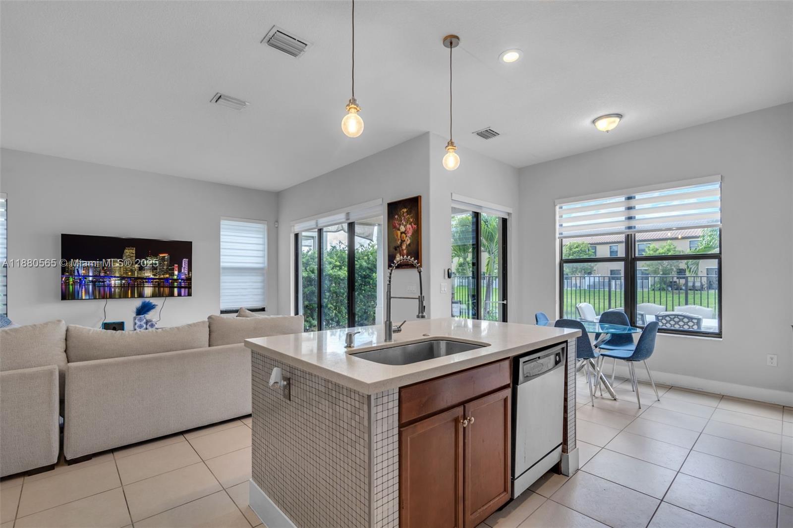 3332 West 95th Terrace, Unit 3332 Hialeah, FL 33018 - Photo 12 of 31 a dining hall with stainless steel appliances granite countertop a sink and a large window