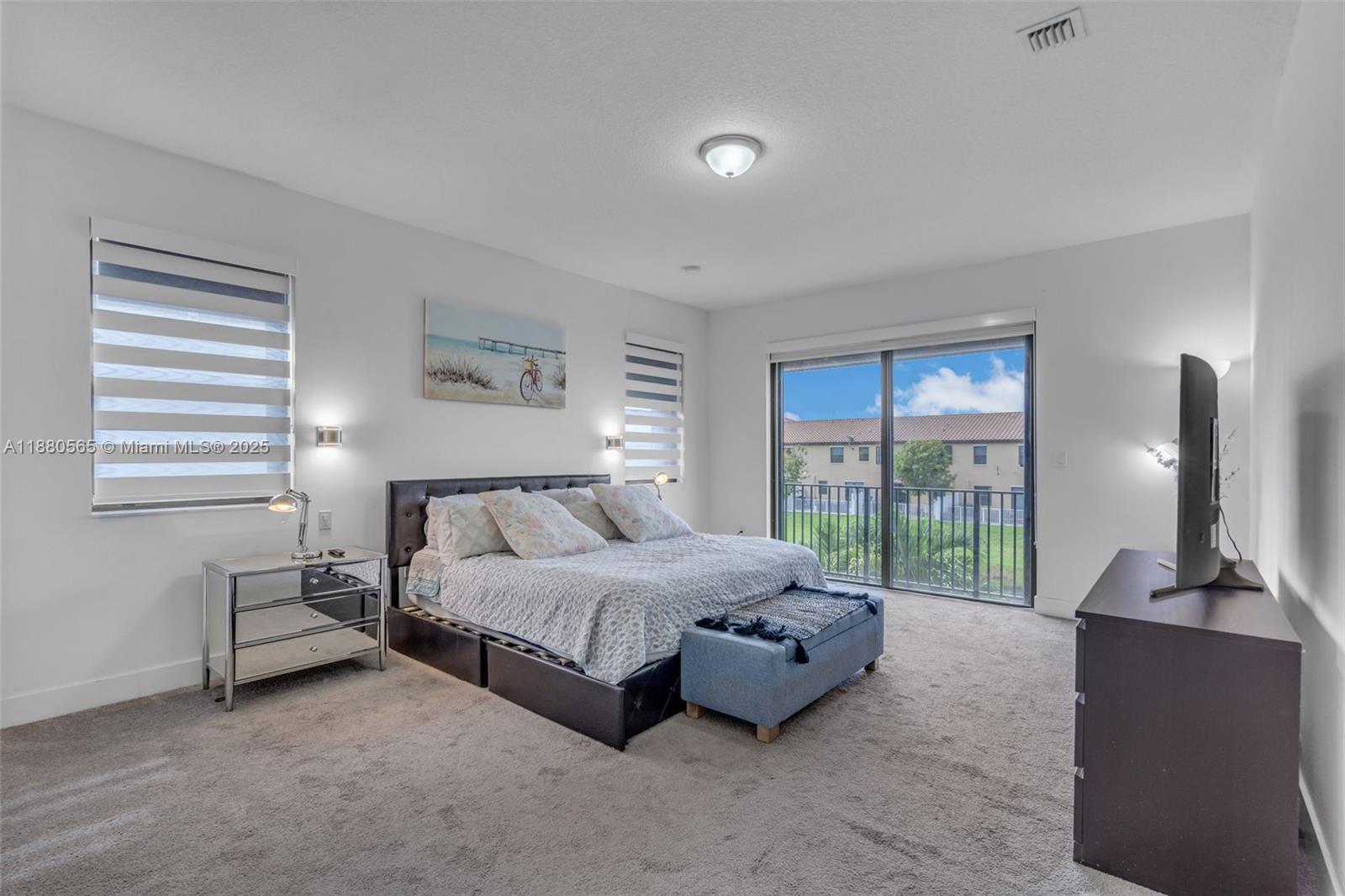 3332 West 95th Terrace, Unit 3332 Hialeah, FL 33018 - Photo 21 of 31 a bedroom with a bed and large window