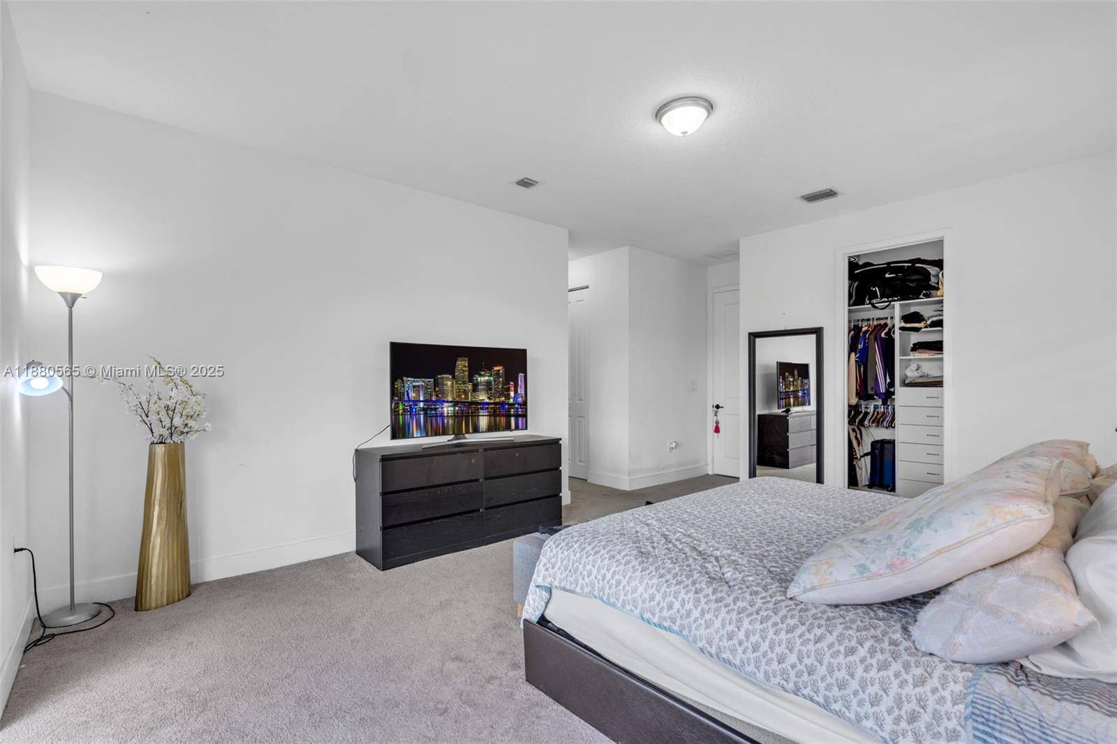 3332 West 95th Terrace, Unit 3332 Hialeah, FL 33018 - Photo 23 of 31 a bedroom with a bed and a flat screen tv