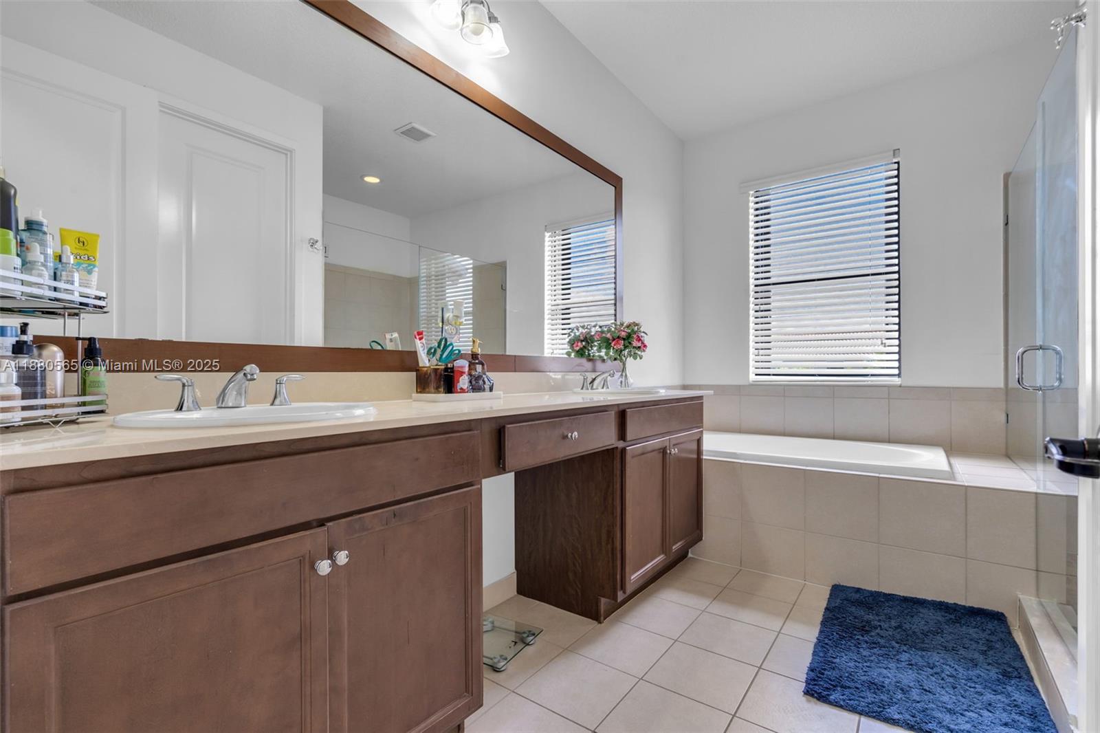 3332 West 95th Terrace, Unit 3332 Hialeah, FL 33018 - Photo 25 of 31 a bathroom with a tub sink and mirror