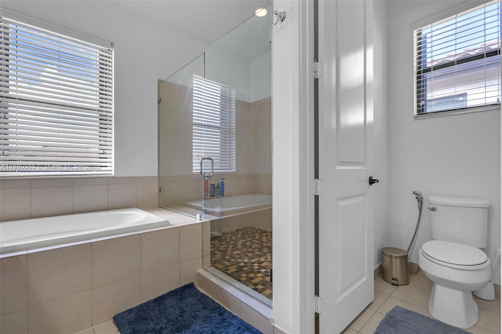 3332 West 95th Terrace, Unit 3332 Hialeah, FL 33018 - Photo 26 of 31 a bathroom with a sink a toilet and shower