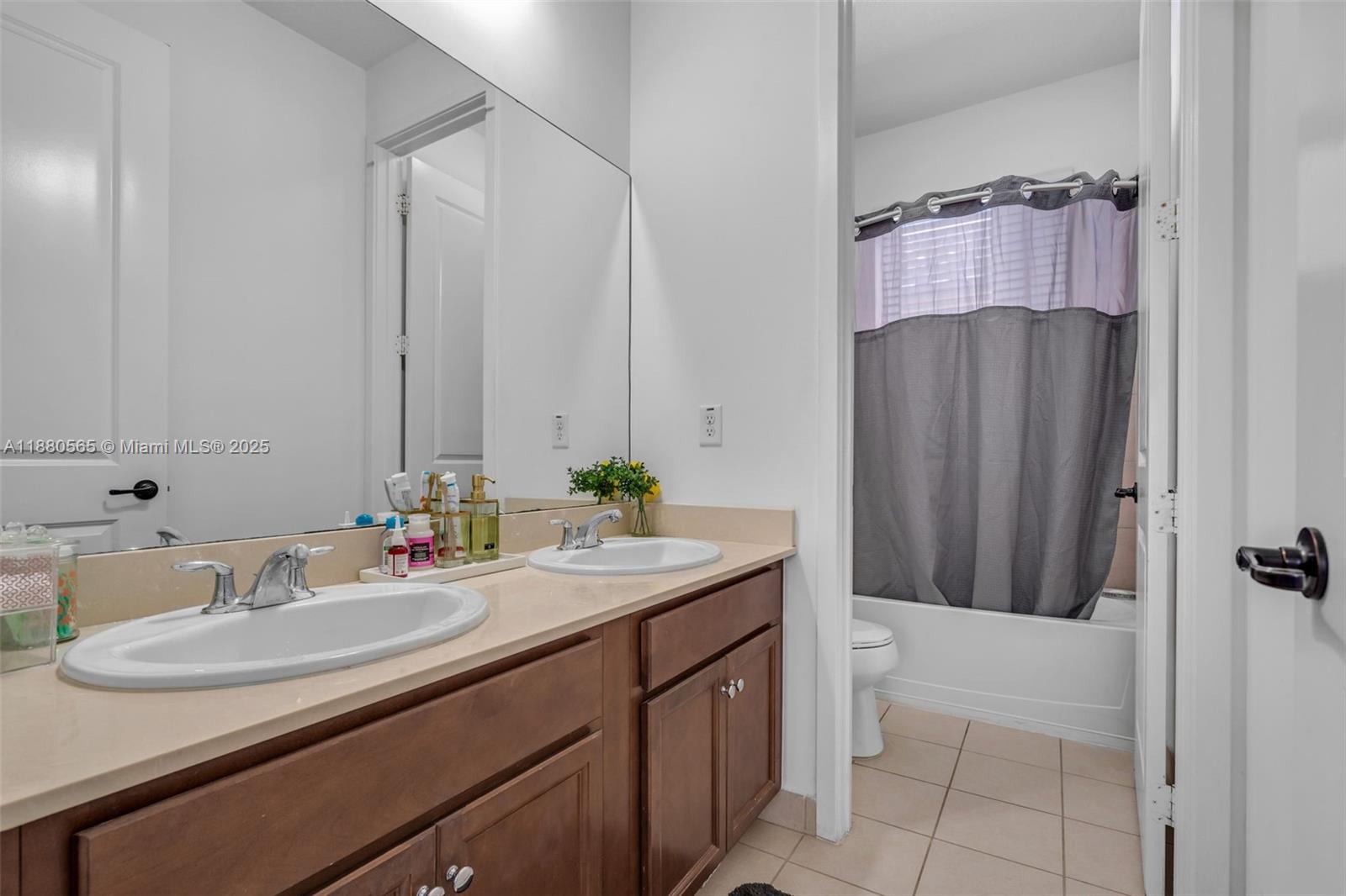 3332 West 95th Terrace, Unit 3332 Hialeah, FL 33018 - Photo 28 of 31 a bathroom with a sink and a mirror