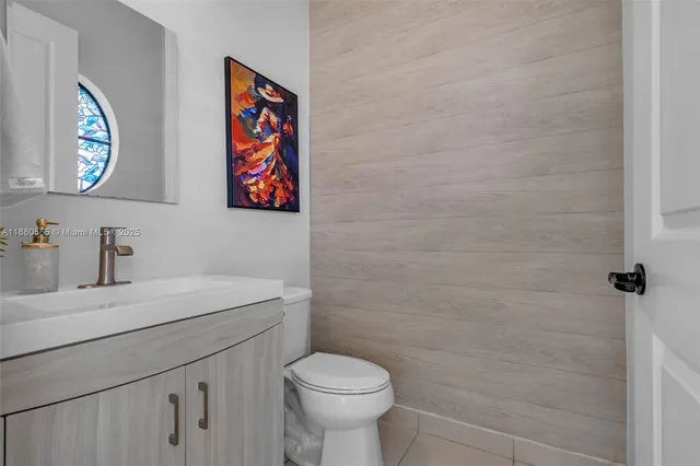 a bathroom with a toilet a sink and mirror