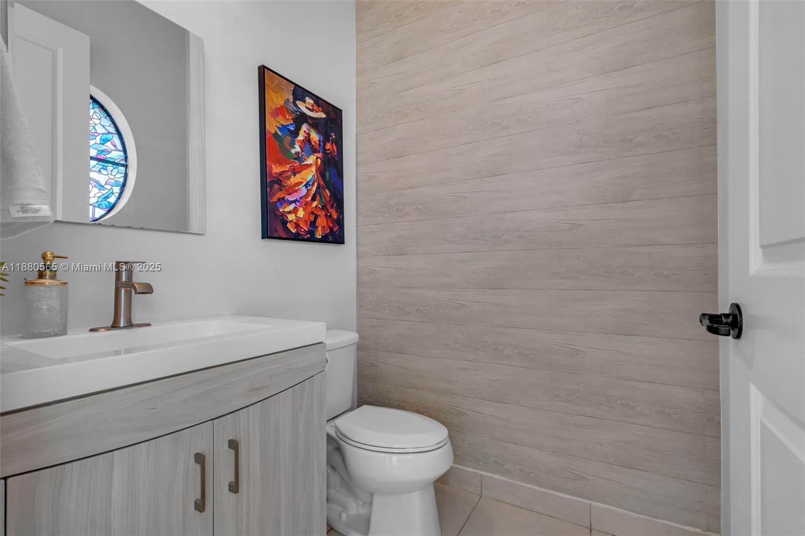 3332 West 95th Terrace, Unit 3332 Hialeah, FL 33018 - Photo 30 of 31 a bathroom with a toilet a sink and mirror