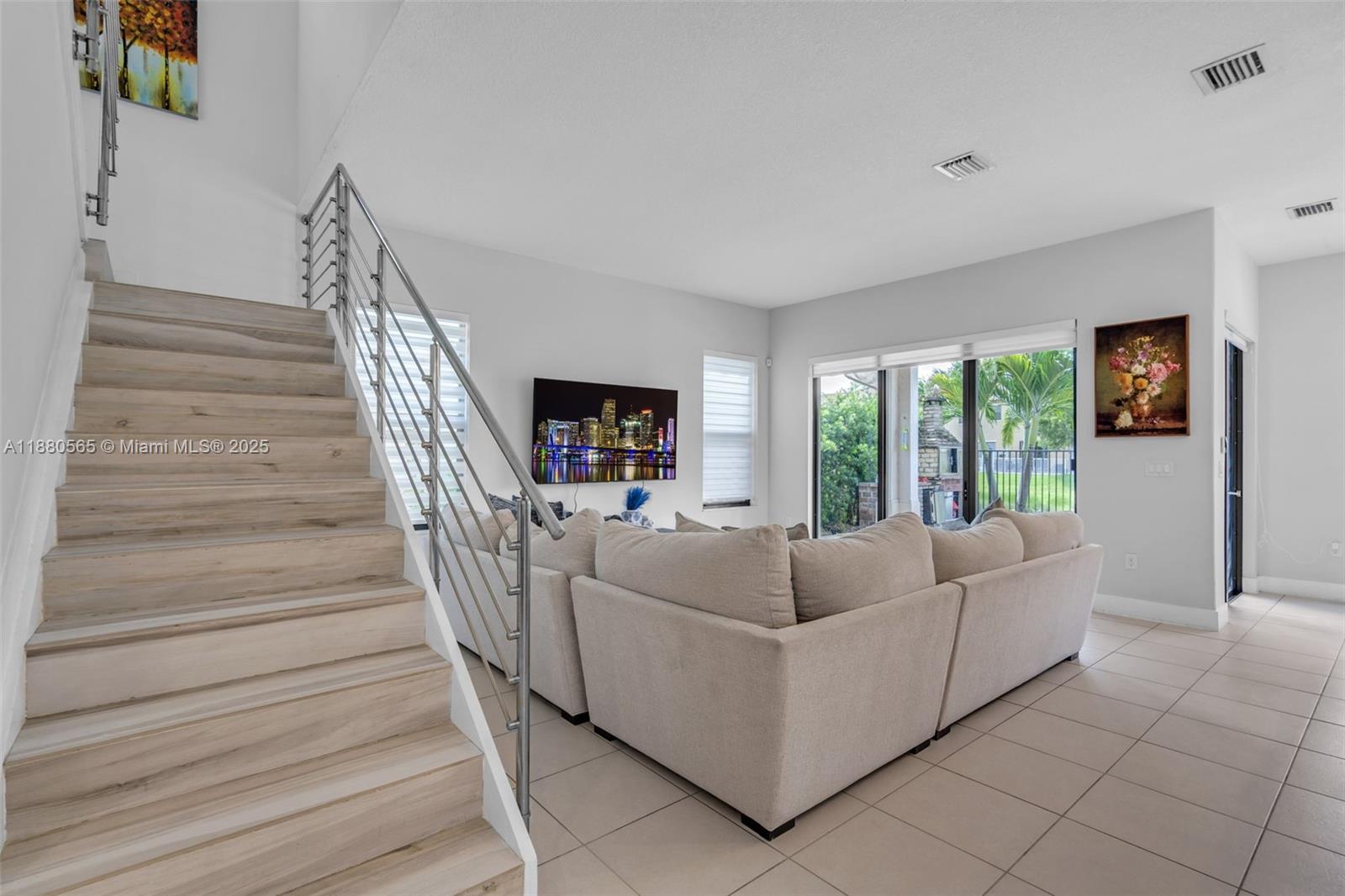 3332 West 95th Terrace, Unit 3332 Hialeah, FL 33018 - Photo 6 of 31 a living room with furniture and a large window