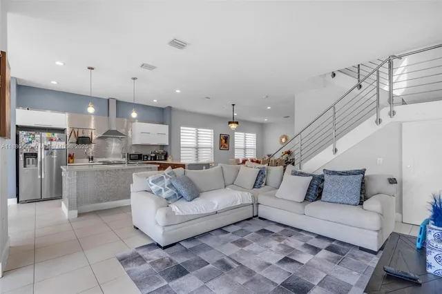 a living room with furniture and kitchen view