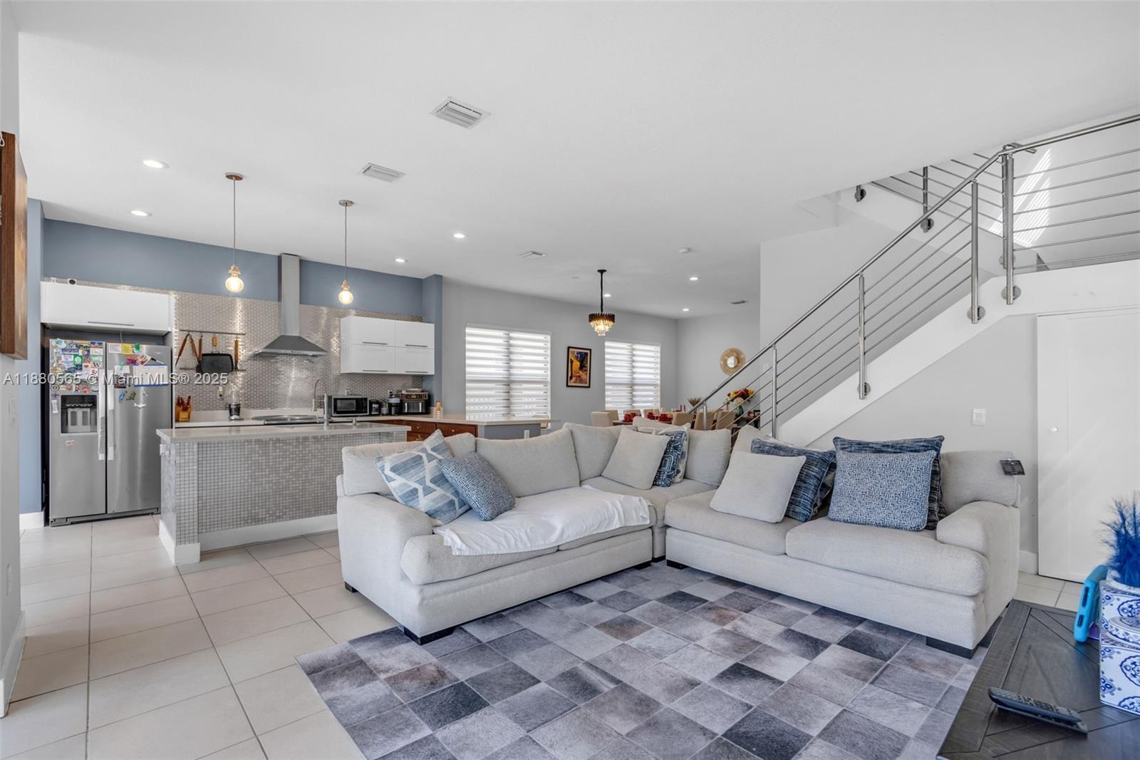 3332 West 95th Terrace, Unit 3332 Hialeah, FL 33018 - Photo 8 of 31 a living room with furniture and kitchen view