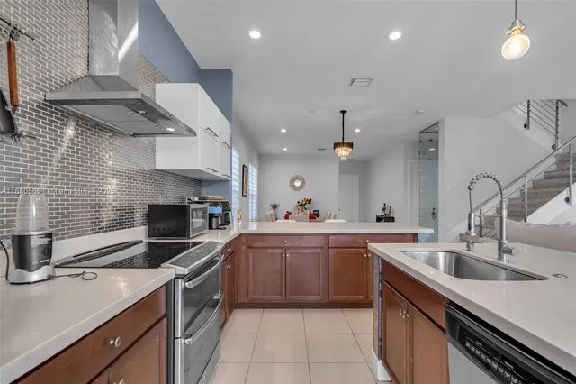 a kitchen with a sink stainless steel appliances and cabinets