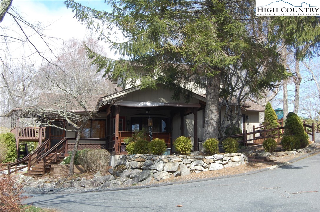 a front view of a house with garden and sitting area