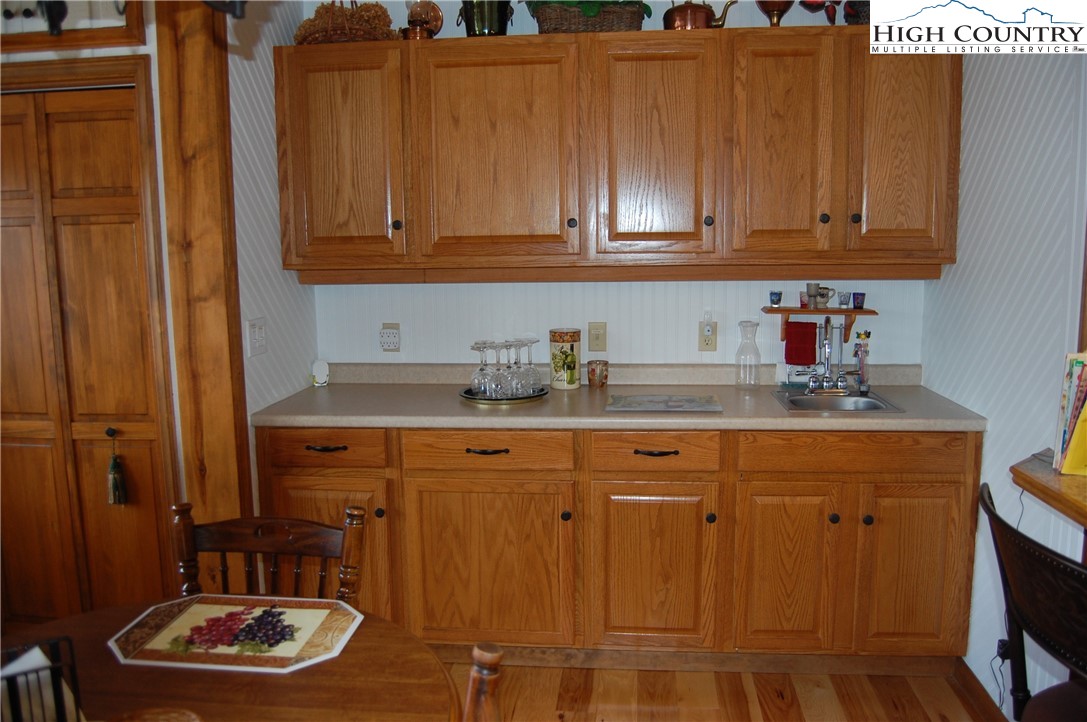 14 Briar Road Newland, NC 28657 - Photo 7 of 37 a kitchen with stainless steel appliances granite countertop a sink a stove and a refrigerator with wooden cabinets