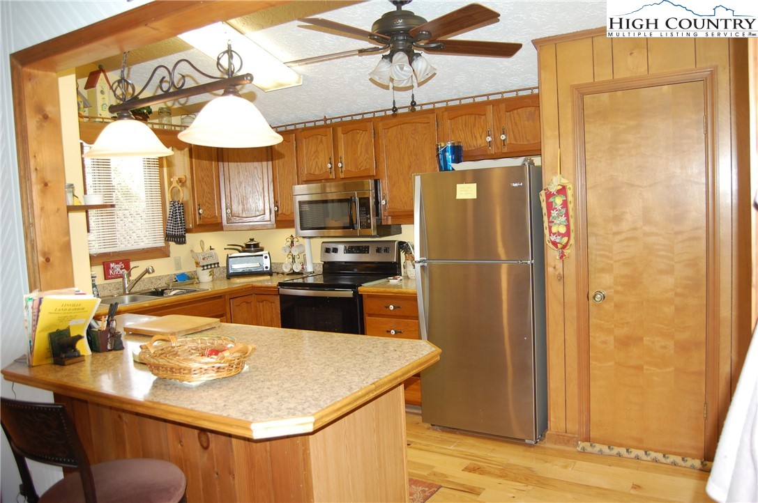 14 Briar Road Newland, NC 28657 - Photo 8 of 37 a kitchen with stainless steel appliances granite countertop a refrigerator a sink and a stove