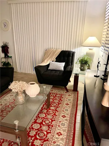 a living room with furniture and a rug