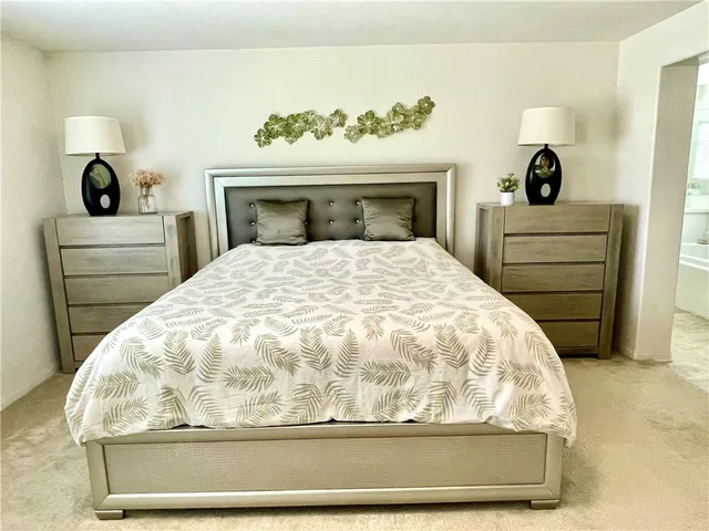 a bedroom with a bed and mirror