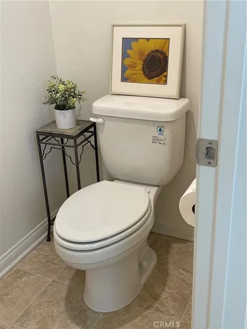 a white toilet sitting next to a bathroom sink
