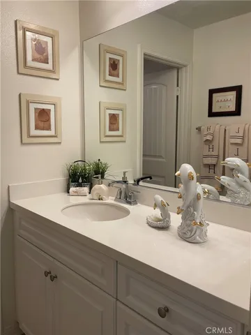 a bathroom with a granite countertop sink a mirror and a bathtub