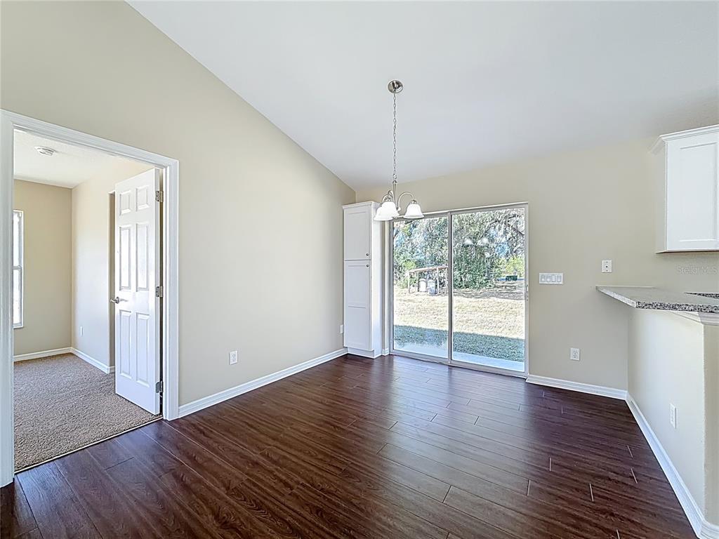 1314 Southwest 68th Avenue Bushnell, FL 33513 - Photo 14 of 33 a view of an empty room with wooden floor and a window