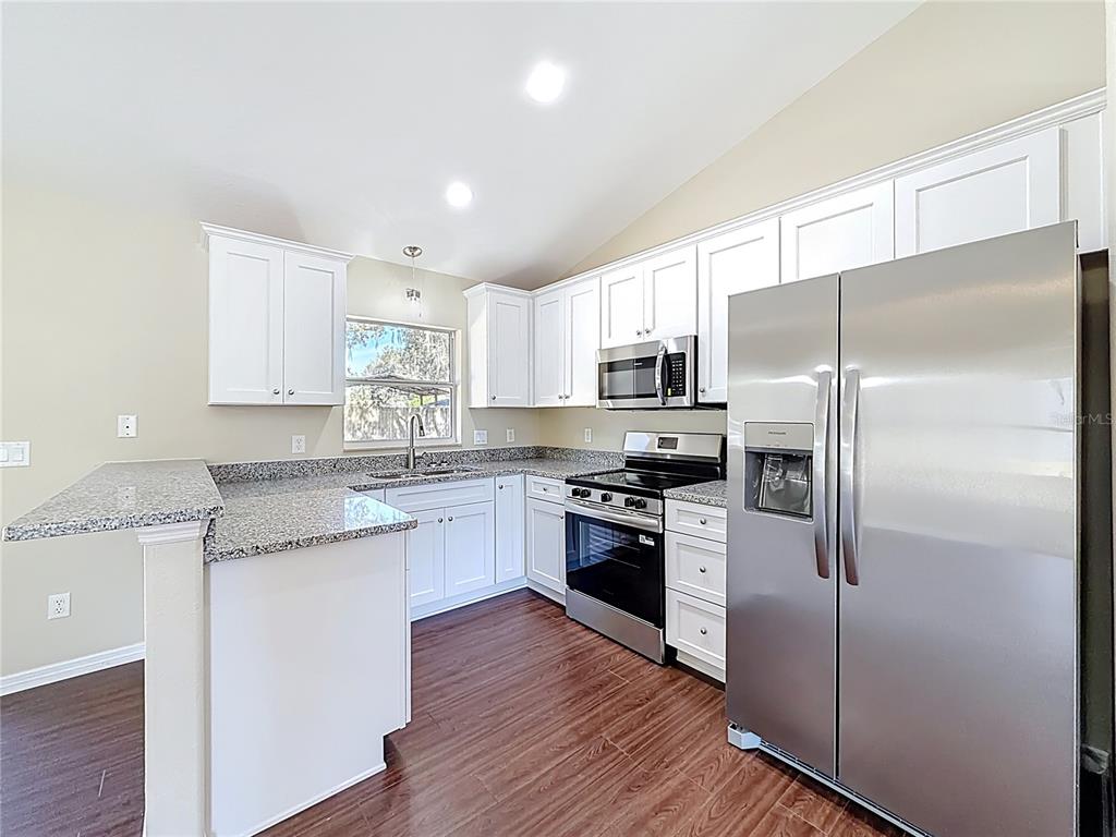 1314 Southwest 68th Avenue Bushnell, FL 33513 - Photo 22 of 33 a kitchen with a refrigerator sink and microwave