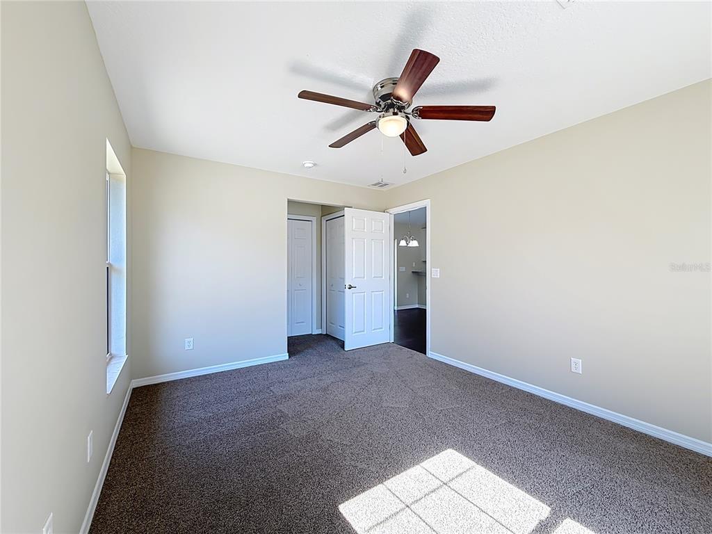 1314 Southwest 68th Avenue Bushnell, FL 33513 - Photo 25 of 33 a view of a big room with a ceiling fan and windows