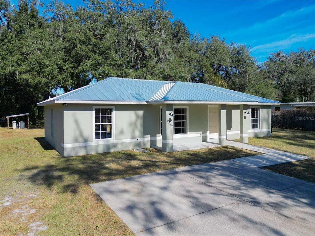 1314 Southwest 68th Avenue Bushnell, FL 33513 - Photo 3 of 33 a front view of a house with a garden