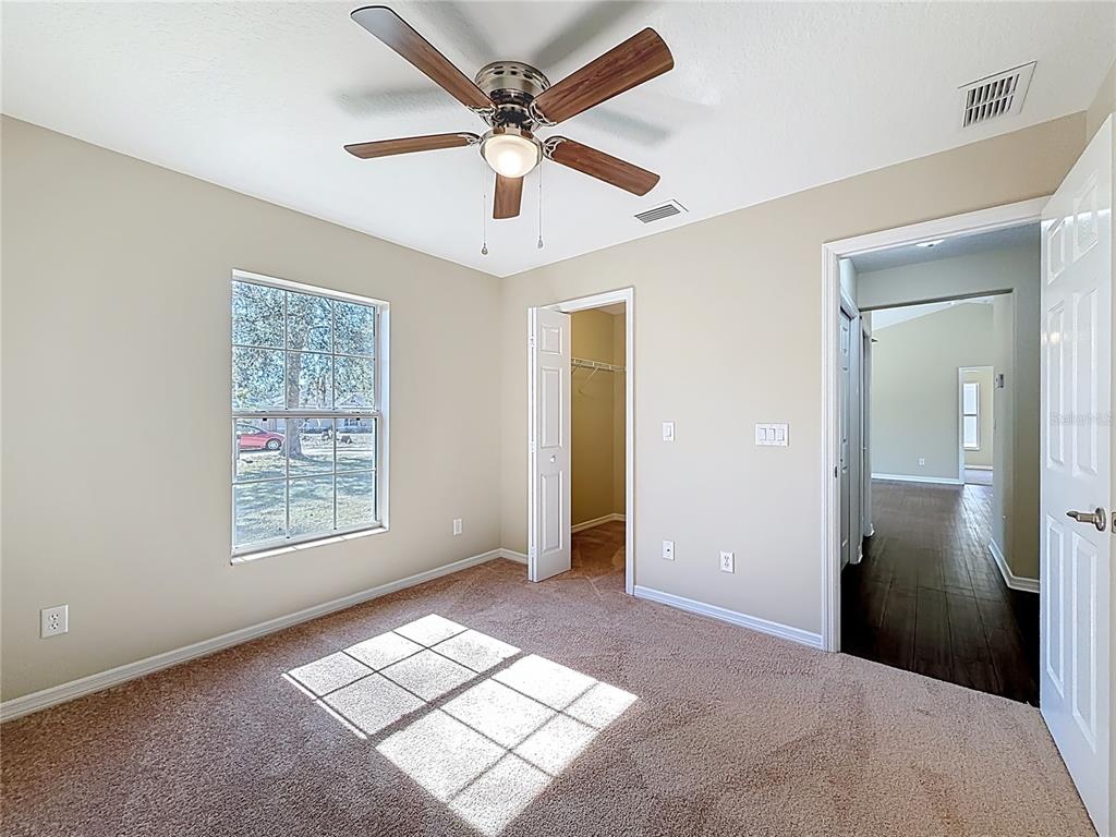 1314 Southwest 68th Avenue Bushnell, FL 33513 - Photo 31 of 33 a view of livingroom with window ceiling fan and hardwood floor
