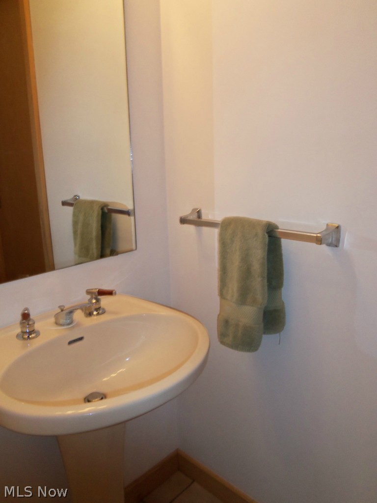 2201 Bennett Road Madison, OH 44057 - Photo 17 of 25 THE ATTRACTIVE GUEST BATHROOM FEATURES A PEDESTAL SINK.