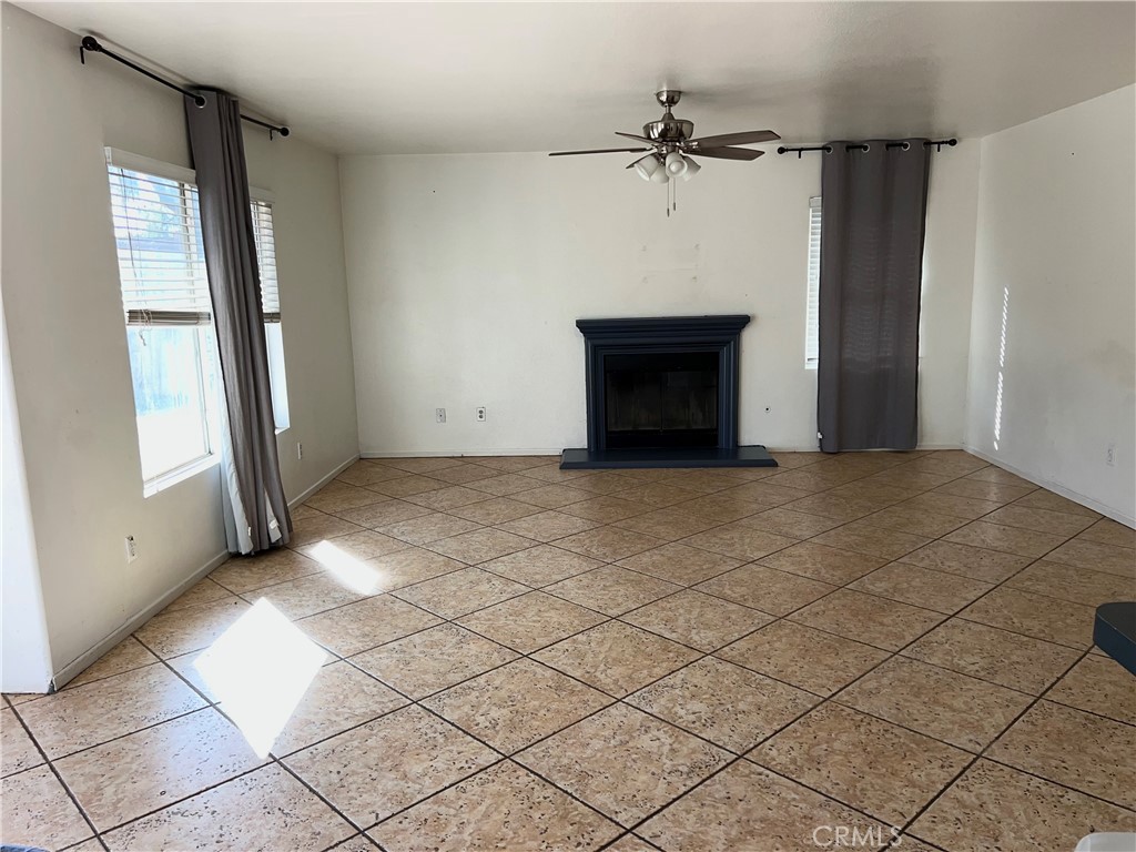 926 Hardwick Avenue Beaumont, CA 92223 - Photo 21 of 29 an empty room with windows and a fireplace