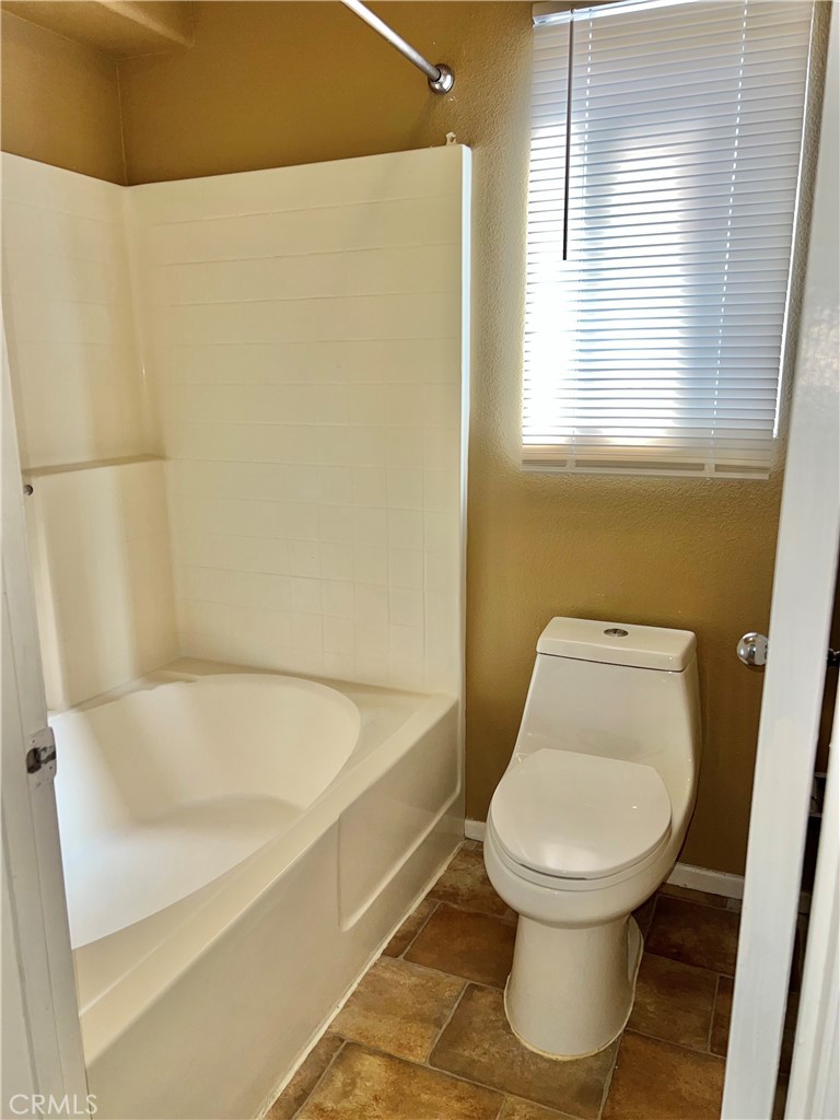 926 Hardwick Avenue Beaumont, CA 92223 - Photo 22 of 29 a white toilet sitting next to a bath tub