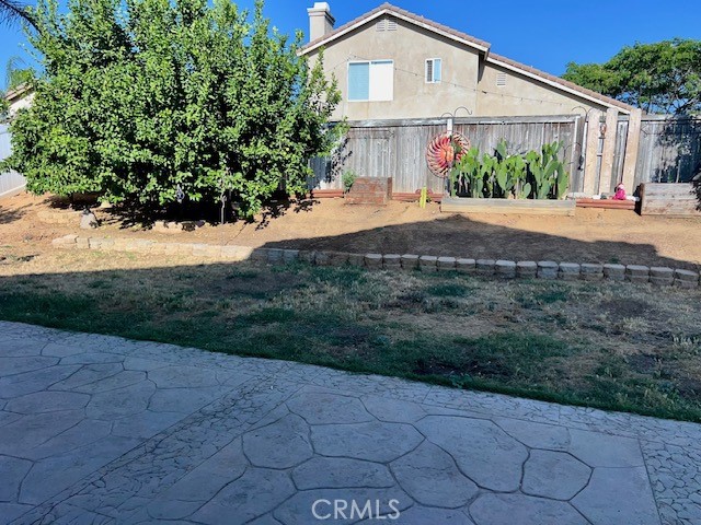 926 Hardwick Avenue Beaumont, CA 92223 - Photo 6 of 29 a front view of a house with a yard and potted plants