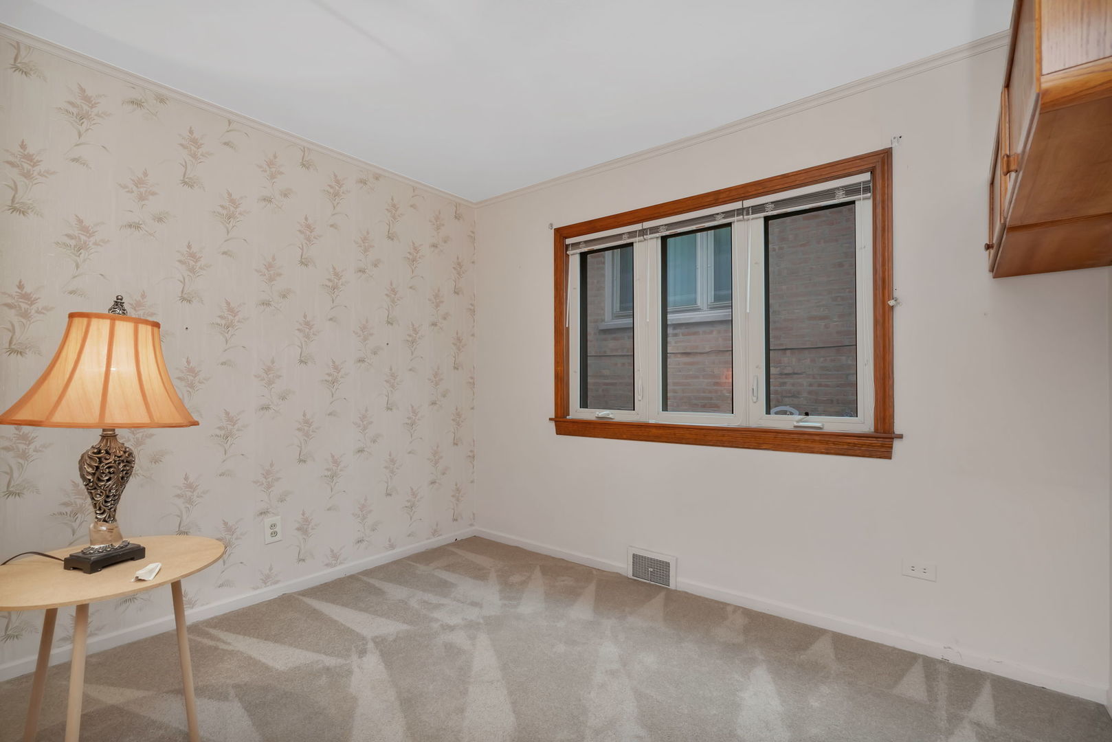 5611 South Monitor Avenue Chicago, IL 60638 - Photo 12 of 24 a view of a room with a lamp and a window